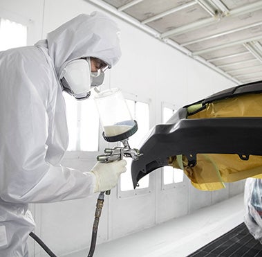 Collision Center Technician Painting a Vehicle | Rochester Toyota in Rochester MN