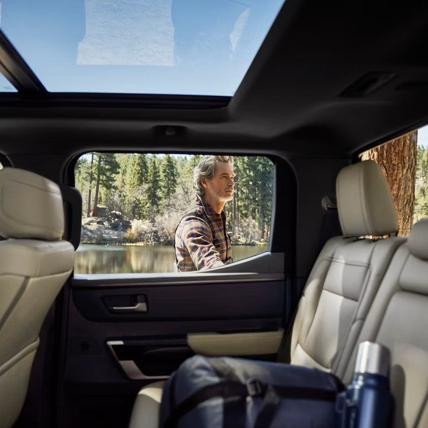 Toyota Tundra CrewMax rear seat with a man outside the open door by a lake