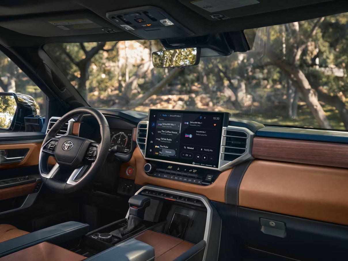 Toyota Tundra dashboard with the touchscreen, steering wheel and brown leather trim