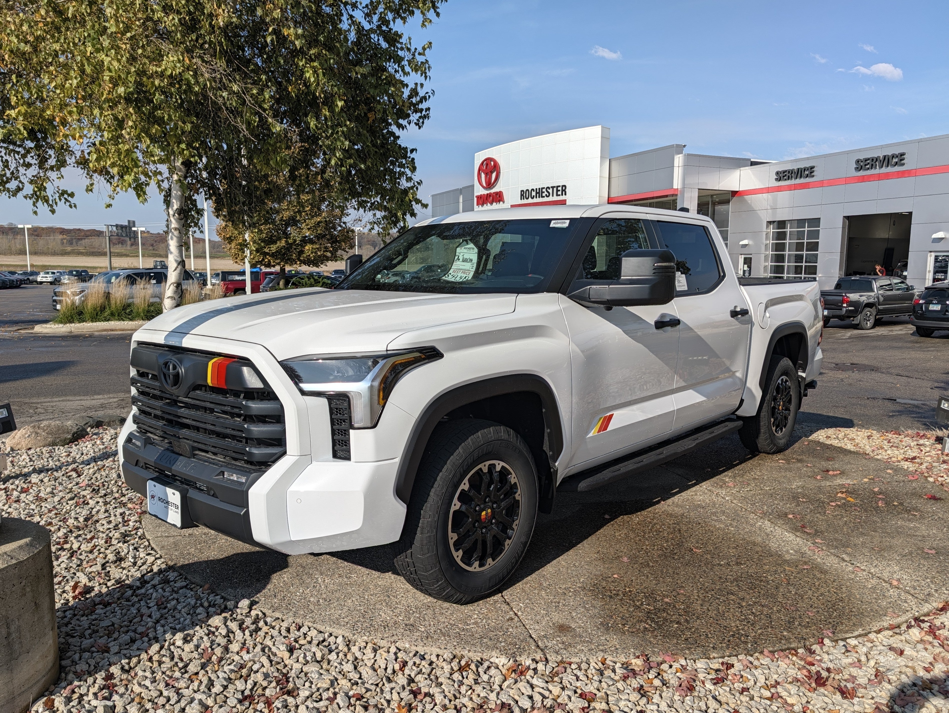 White Toyota Tundra with a TRD stripe on the lot at Rochester Toyota in Rochester, MN
