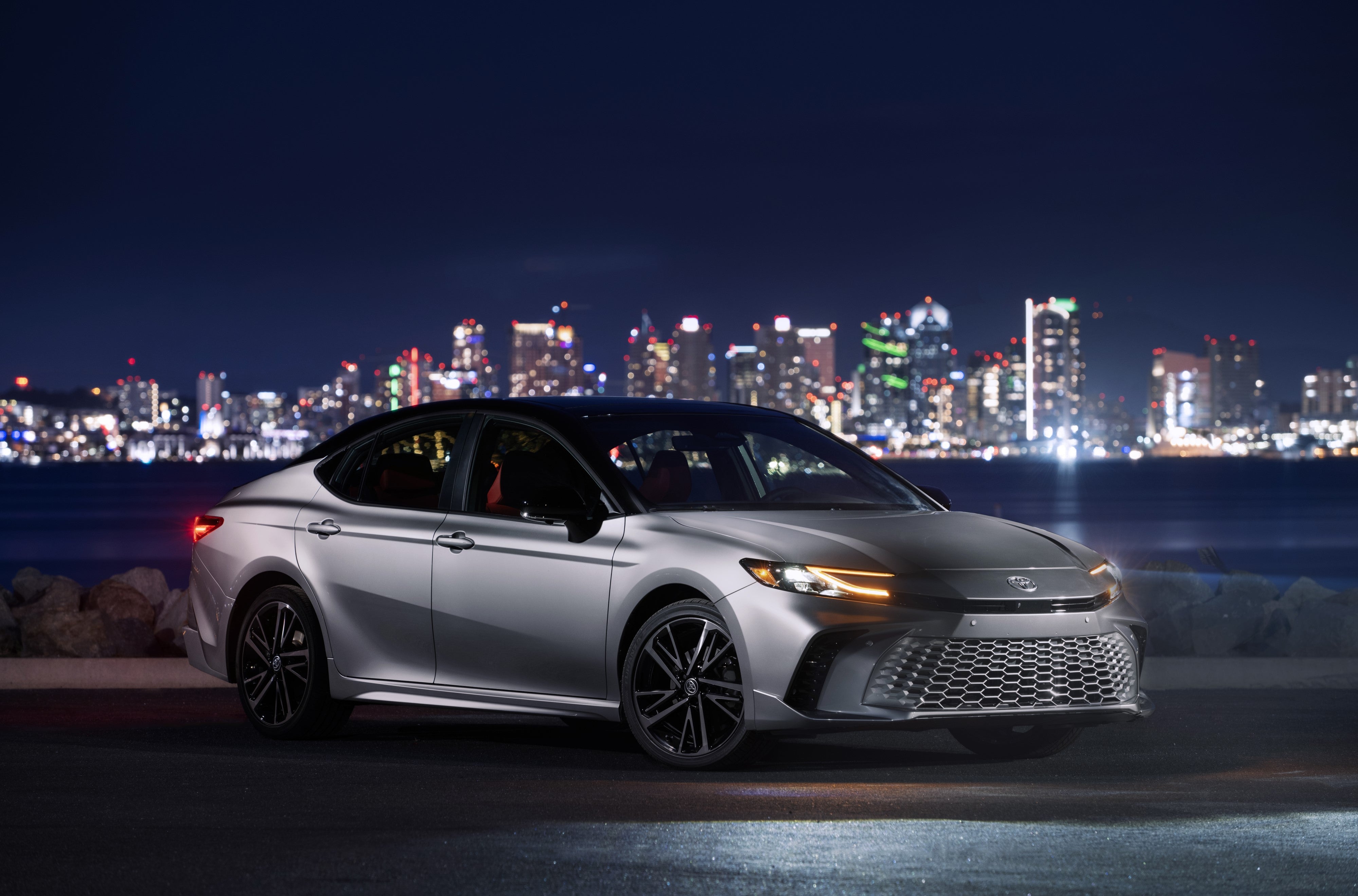 2027 Toyota Camry XSE parked in front of a cityscape