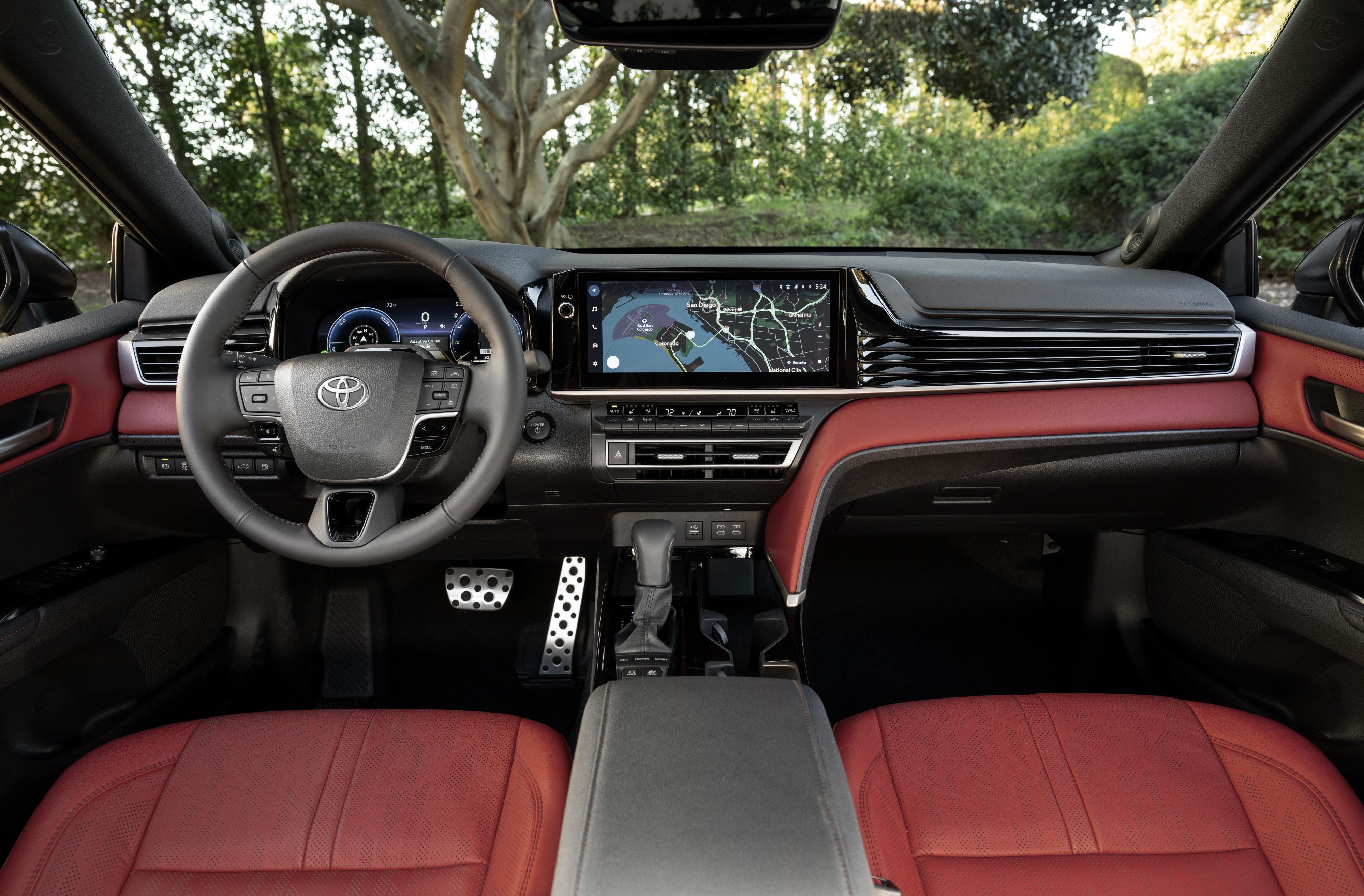 Front seats, touchscreen and dual-zone climate controls inside a 2027 Toyota Camry XSE